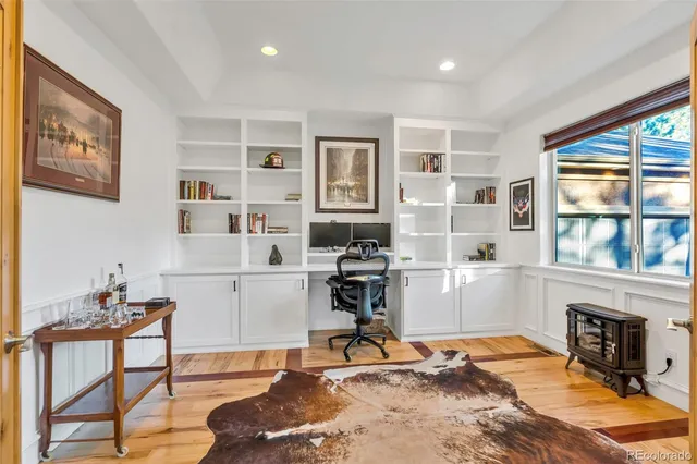 a living room with furniture a floor to ceiling window and a flat screen tv