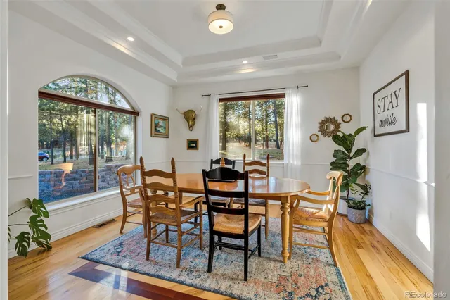 a kitchen with stainless steel appliances granite countertop a stove a sink a oven a dining table and chairs