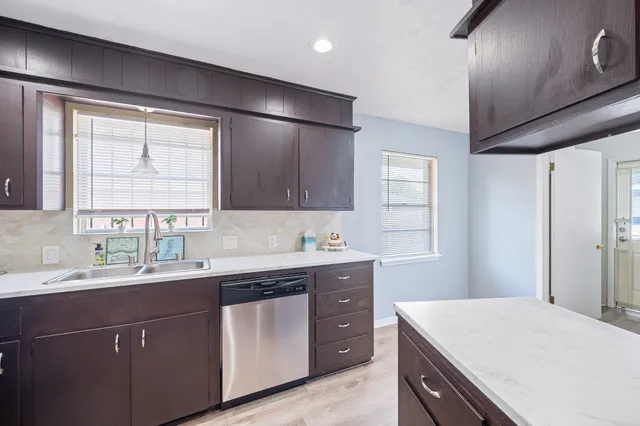 a kitchen with a sink stove and cabinets