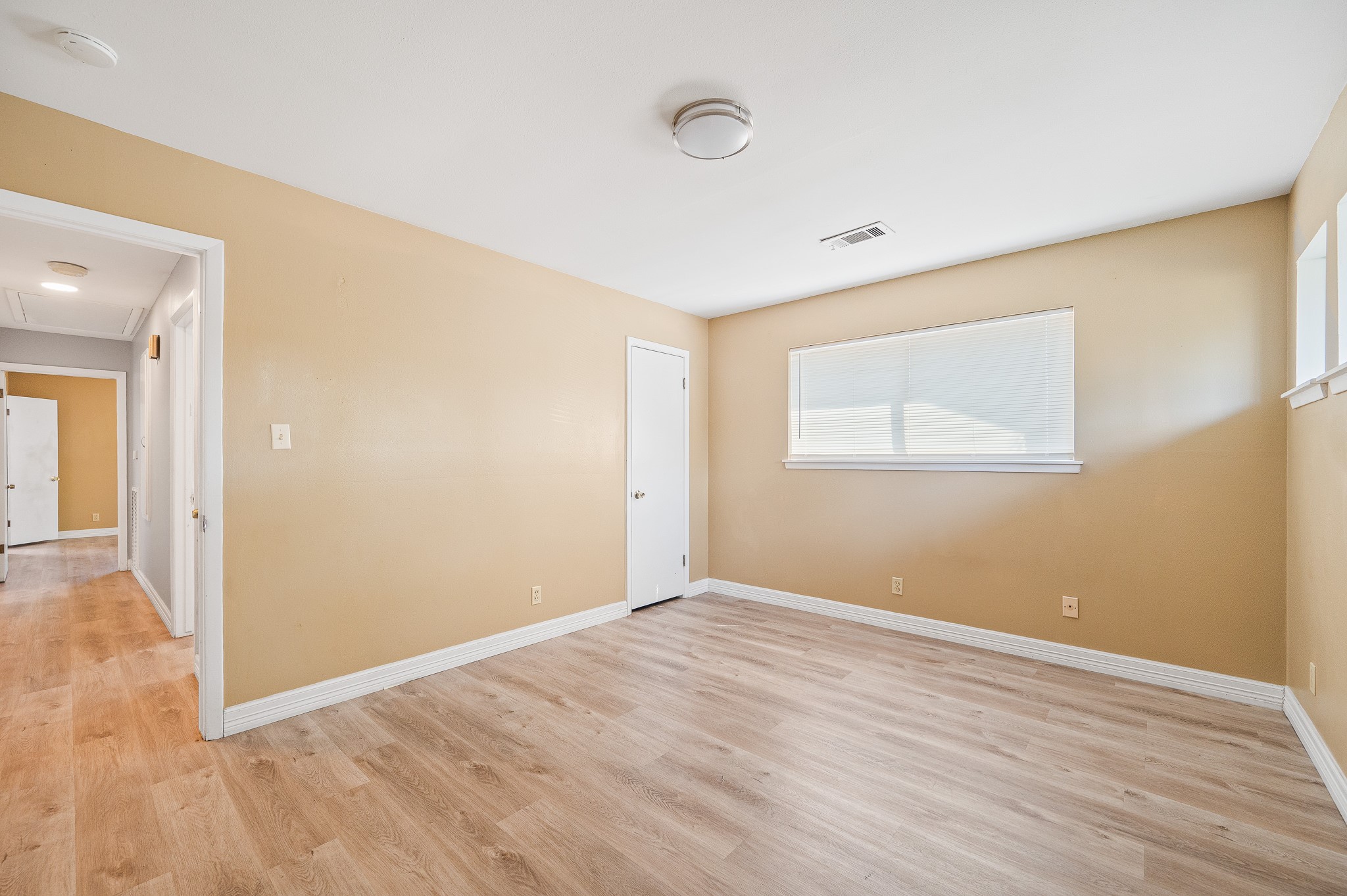 8314 Edgemoor Drive Houston, TX 77036 - Photo 21 of 34 a view of an empty room with wooden floor and a window