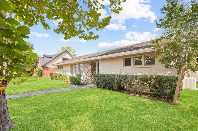 a view of a house with yard and a garden