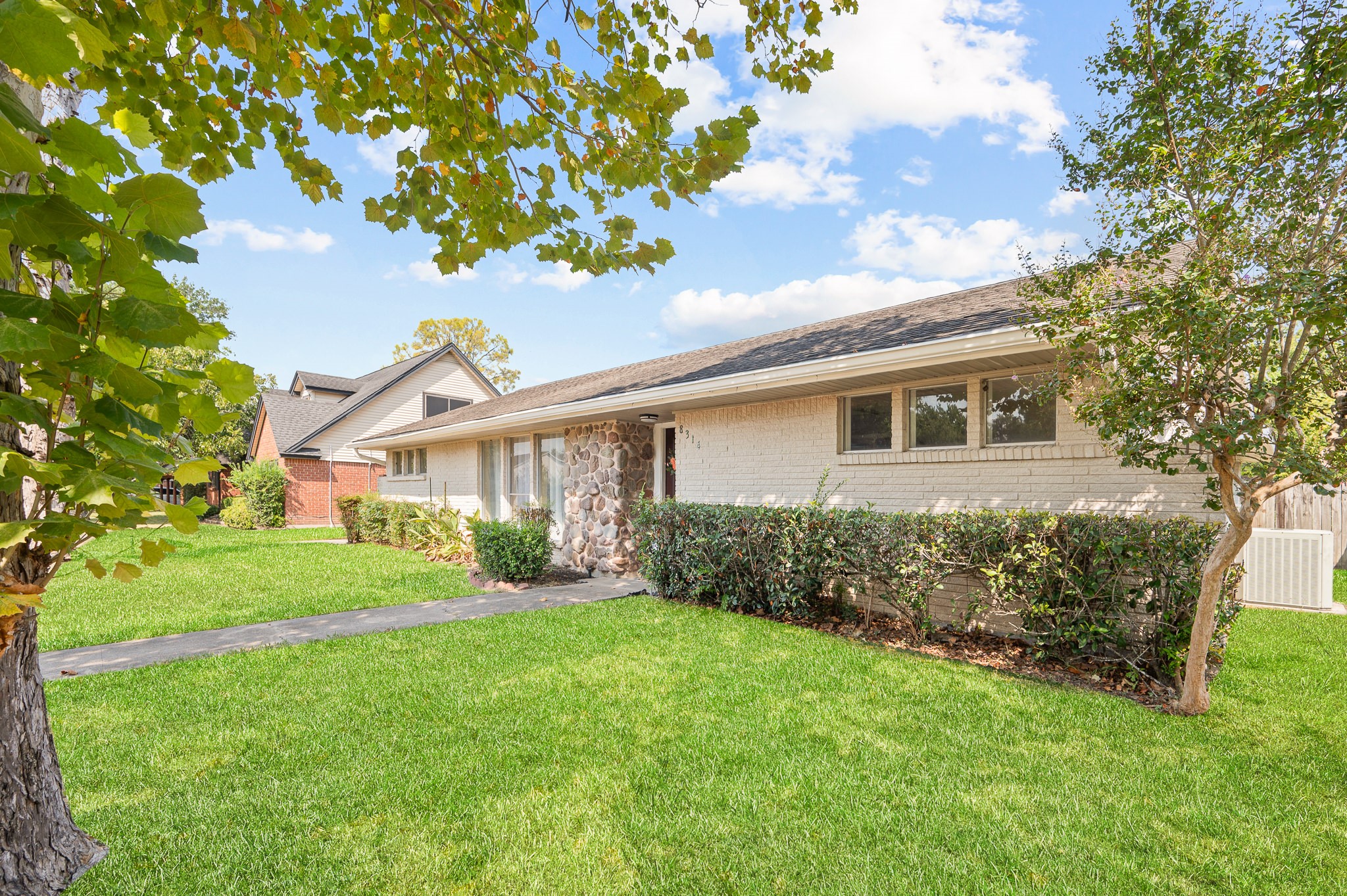 8314 Edgemoor Drive Houston, TX 77036 - Photo 3 of 34 a view of a house with yard and a garden