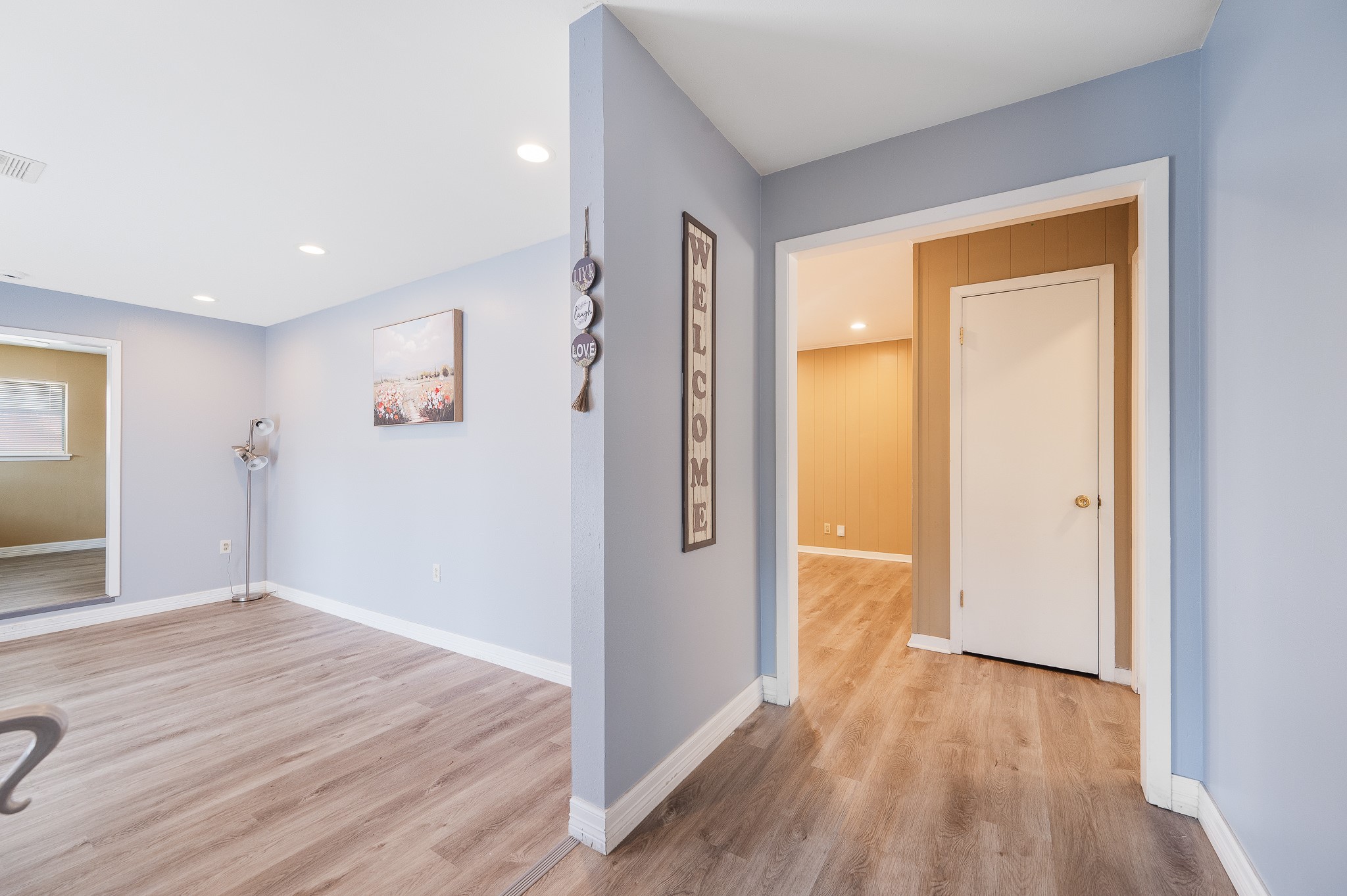 8314 Edgemoor Drive Houston, TX 77036 - Photo 4 of 34 a view of a hallway with wooden floor and a bathroom