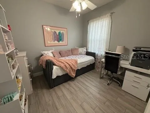 a bedroom with a bed window and a desk