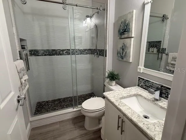 a bathroom with a sink toilet and shower