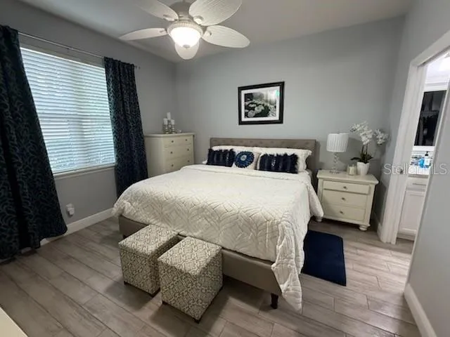 a bedroom with a bed mirror and window