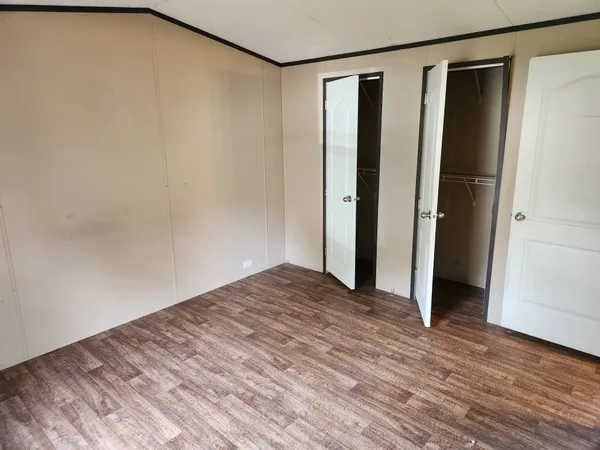 a view of hallway with wooden floor