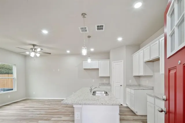 a bathroom with a sink double vanity granite and a shower