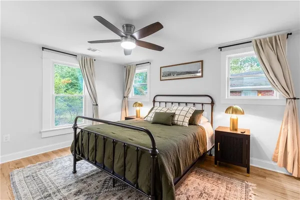 a bedroom with a large bed and a window