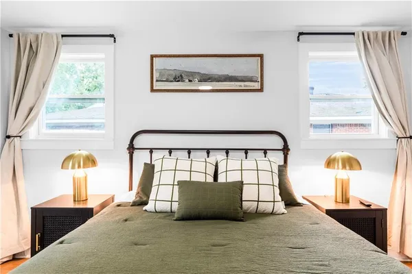 a bedroom with a bed and window with on the wall