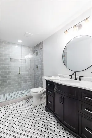 a bathroom with a toilet a sink and mirror