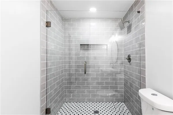 a bathroom with a shower and a toilet