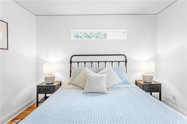 a bedroom with a bed and a night stand