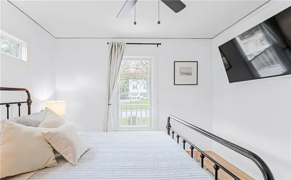 a bedroom with a bed and a window