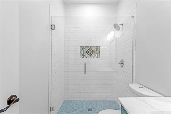 a bathroom with a shower and toilet
