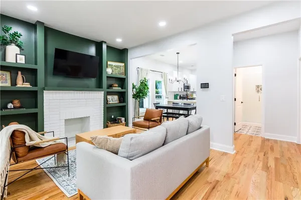 a living room with fireplace furniture and a flat screen tv