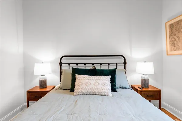 a bedroom with a bed and a night stand