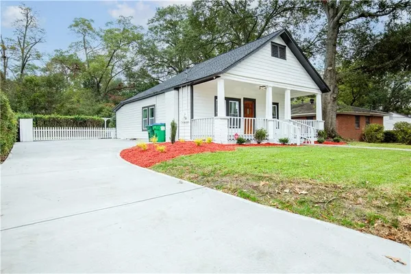 a front view of house with yard and green space