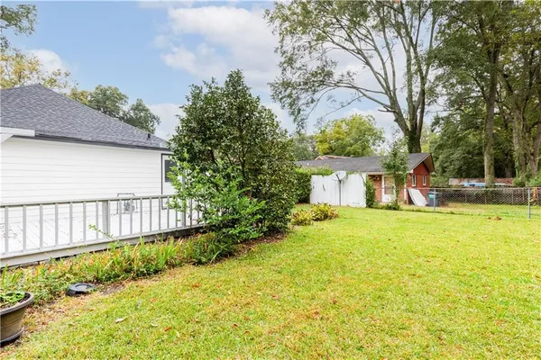 a view of a house with a yard and a garden
