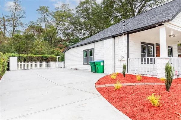 a view of backyard with furniture and tree