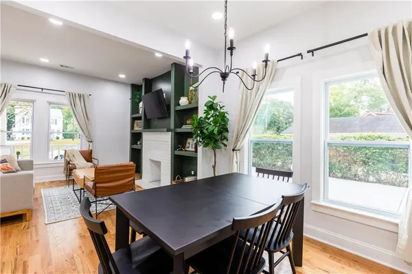 a view of a dining room with furniture window and wooden floor
