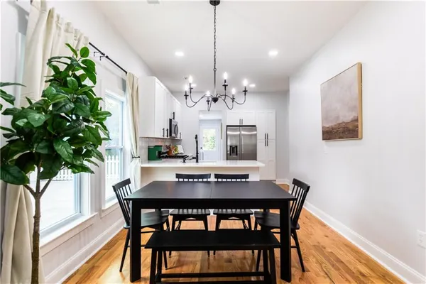 a view of a dining room with furniture and chandelier