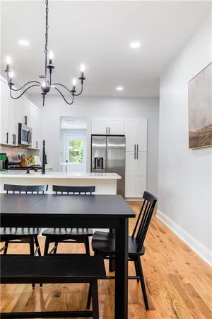 a view of a dining room with furniture and wooden floor