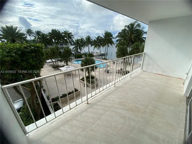 a swimming pool with outdoor seating and a patio