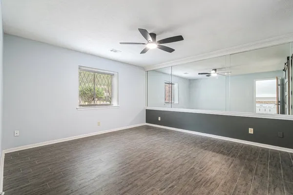 a view of wooden floor and windows in a room