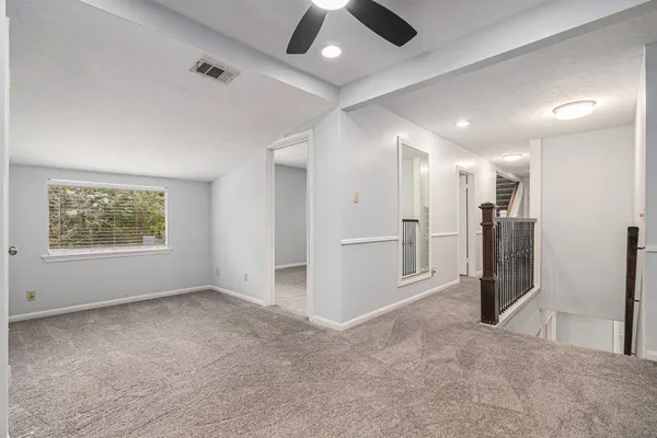 an empty room with a empty space and a ceiling fan