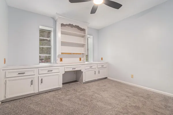 an empty room with windows and pillars in it