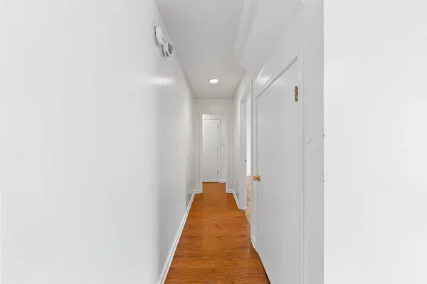 a view of a hallway with a white door