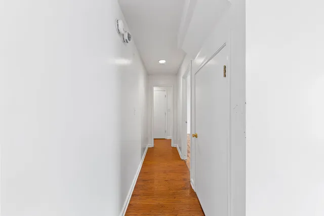 a view of a hallway with a white door