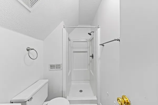 a bathroom with a shower and toilet