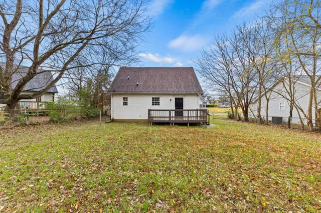 a house view with swimming pool in front of it