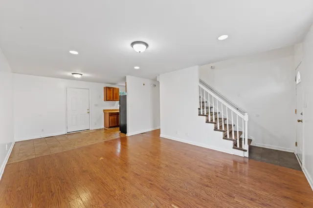 a view of an empty room with wooden floor