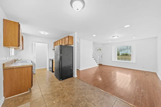 a view of kitchen with stainless steel appliances granite countertop cabinets and refrigerator