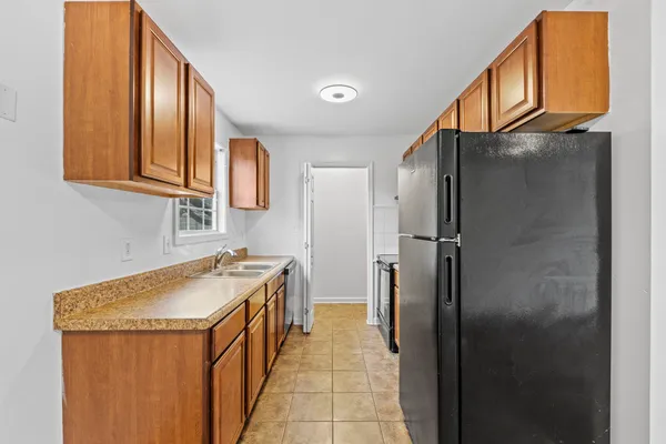 a kitchen with stainless steel appliances granite countertop a refrigerator and a sink