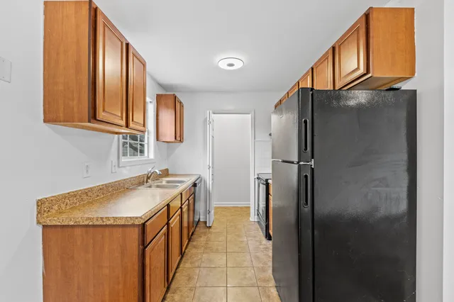 a kitchen with stainless steel appliances granite countertop a refrigerator and a sink