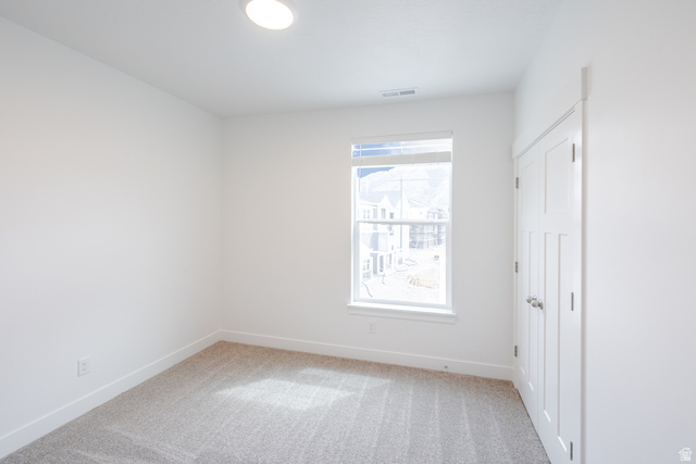 693 West 4500th South, Unit O303 Mapleton, UT 84664 - Photo 7 of 15 Spare room featuring light carpet and baseboards