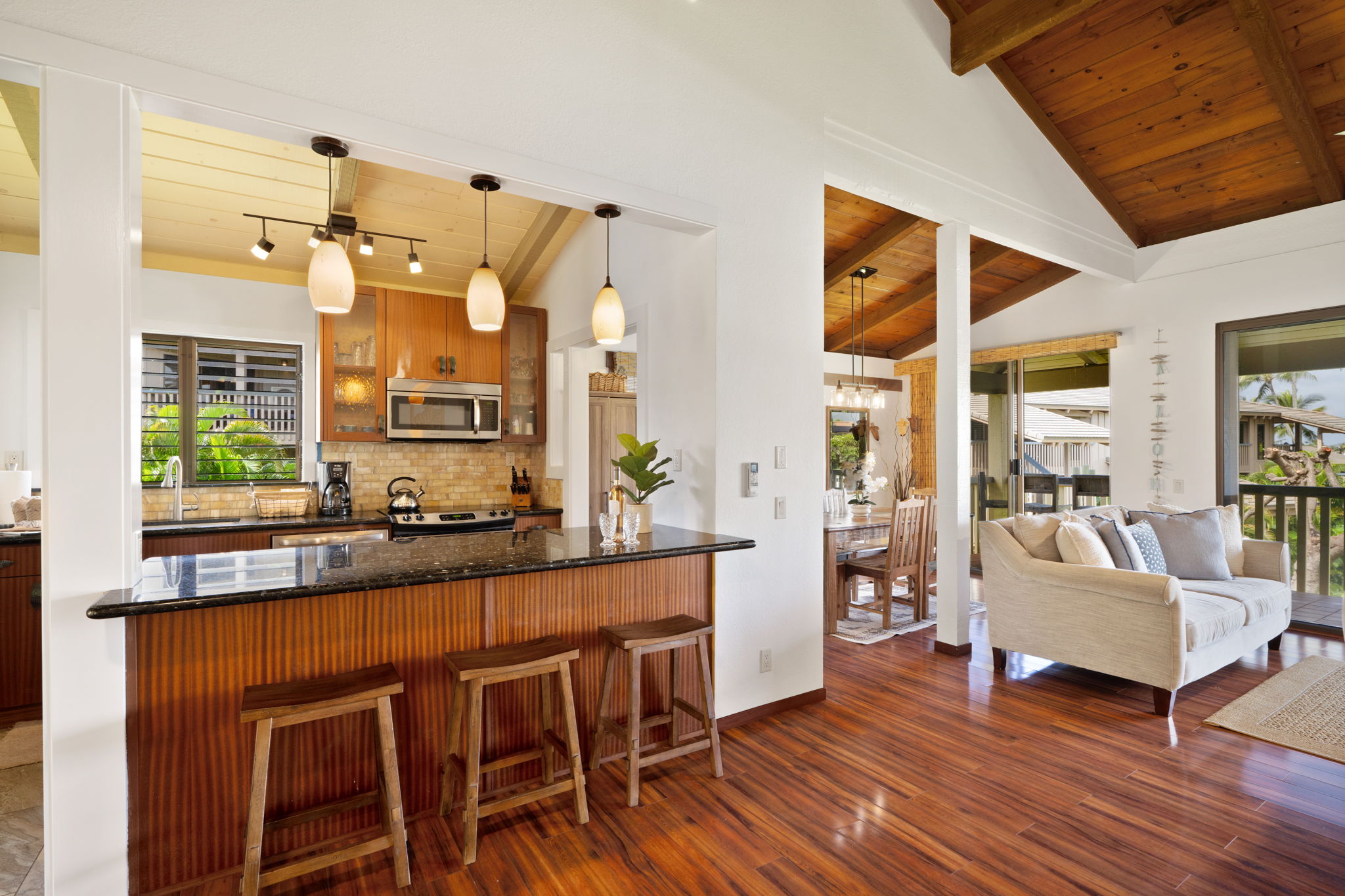 1870 Hoone Road, Unit 600 Koloa, HI 96756 - Photo 14 of 30 a kitchen with a table chairs refrigerator and cabinets