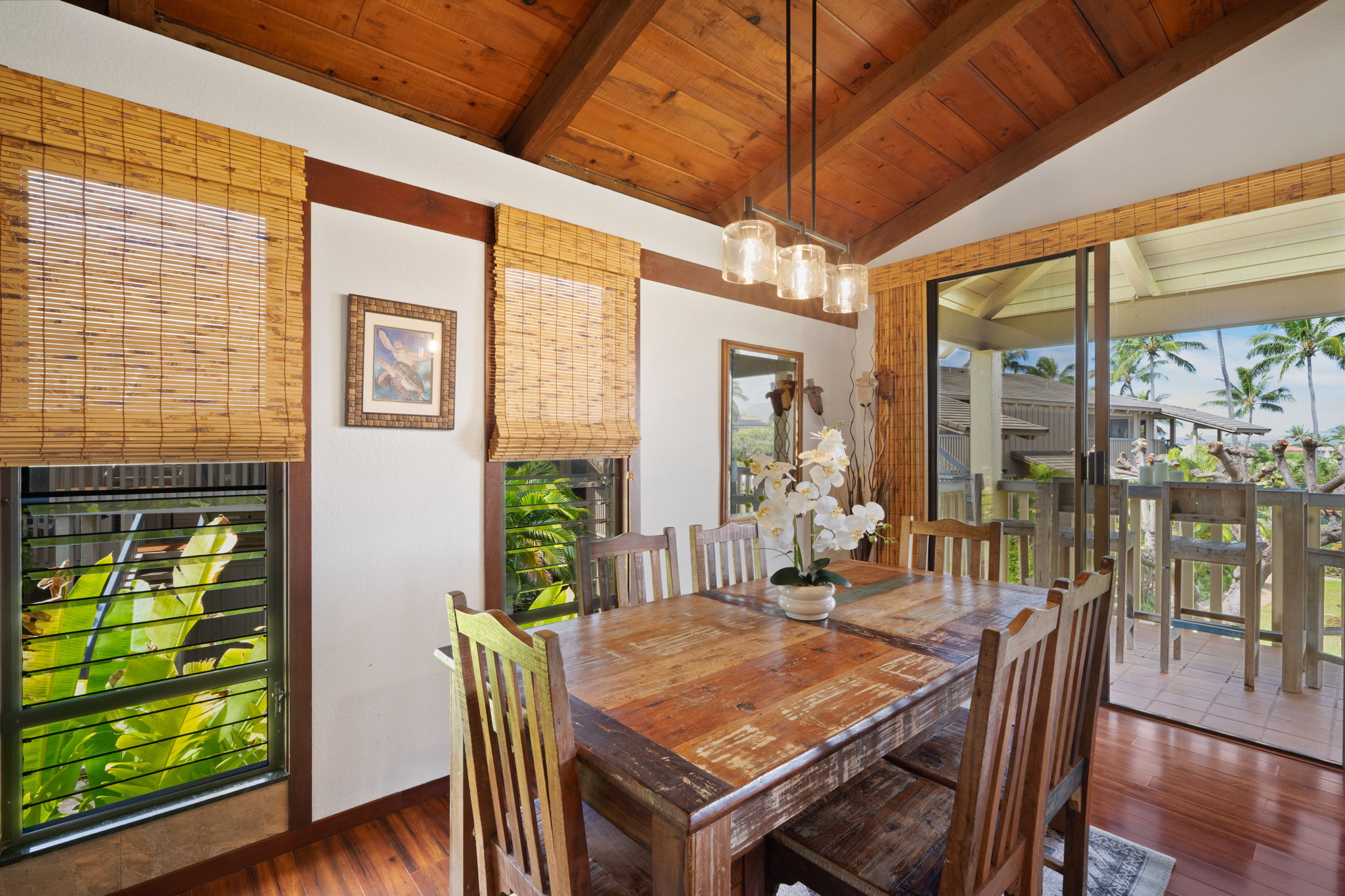 1870 Hoone Road, Unit 600 Koloa, HI 96756 - Photo 15 of 30 a dining room with furniture a rug and wooden floor
