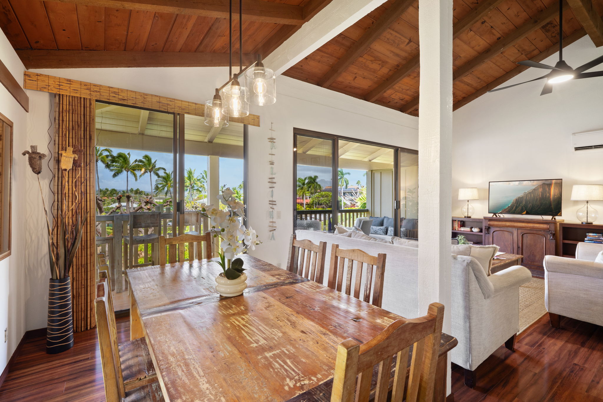 1870 Hoone Road, Unit 600 Koloa, HI 96756 - Photo 16 of 30 a view of a dining room with furniture wooden floor and chandelier