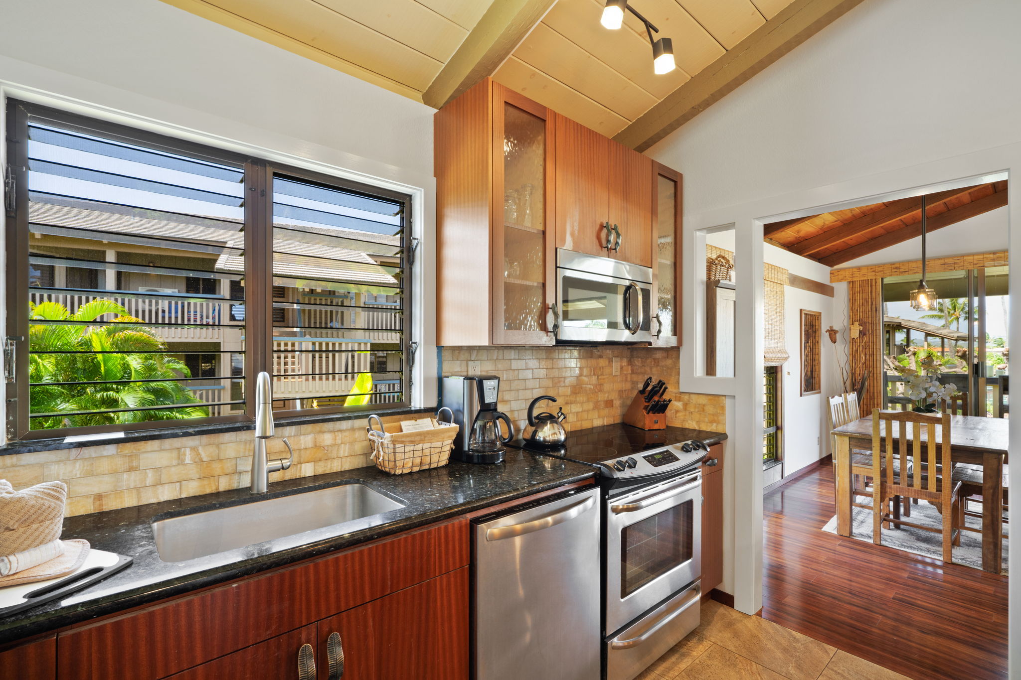1870 Hoone Road, Unit 600 Koloa, HI 96756 - Photo 19 of 30 a kitchen with stainless steel appliances granite countertop a sink and a counter