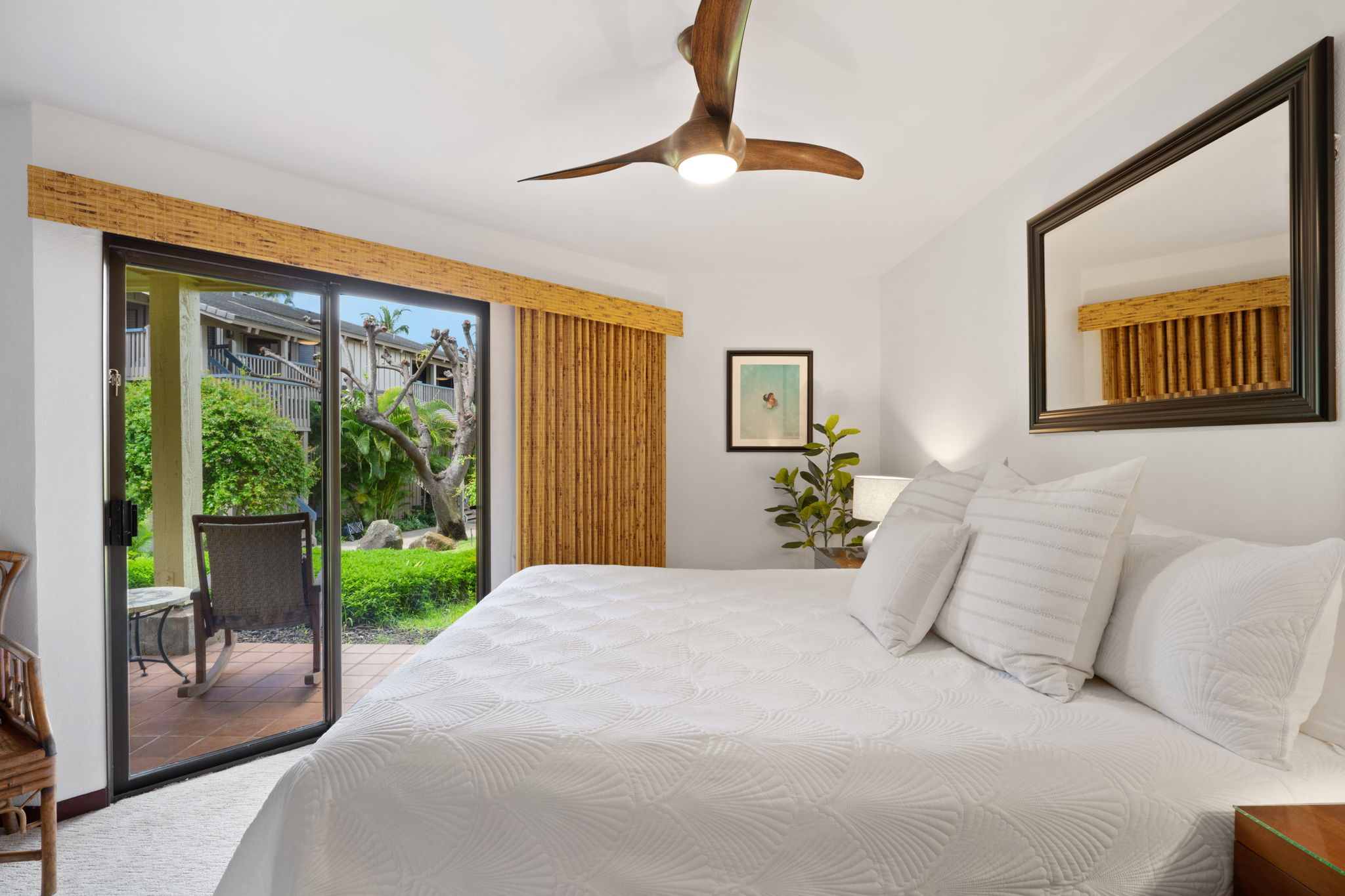 1870 Hoone Road, Unit 600 Koloa, HI 96756 - Photo 21 of 30 a bedroom with a large bed and a chandelier