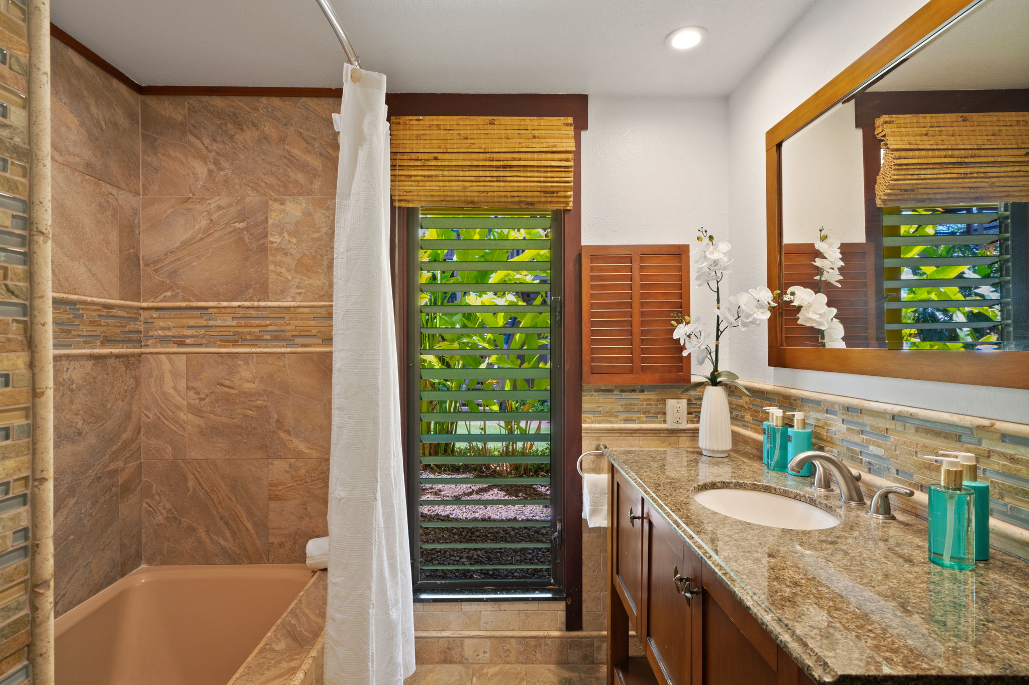 1870 Hoone Road, Unit 600 Koloa, HI 96756 - Photo 22 of 30 a bathroom with a granite countertop sink and a bathtub