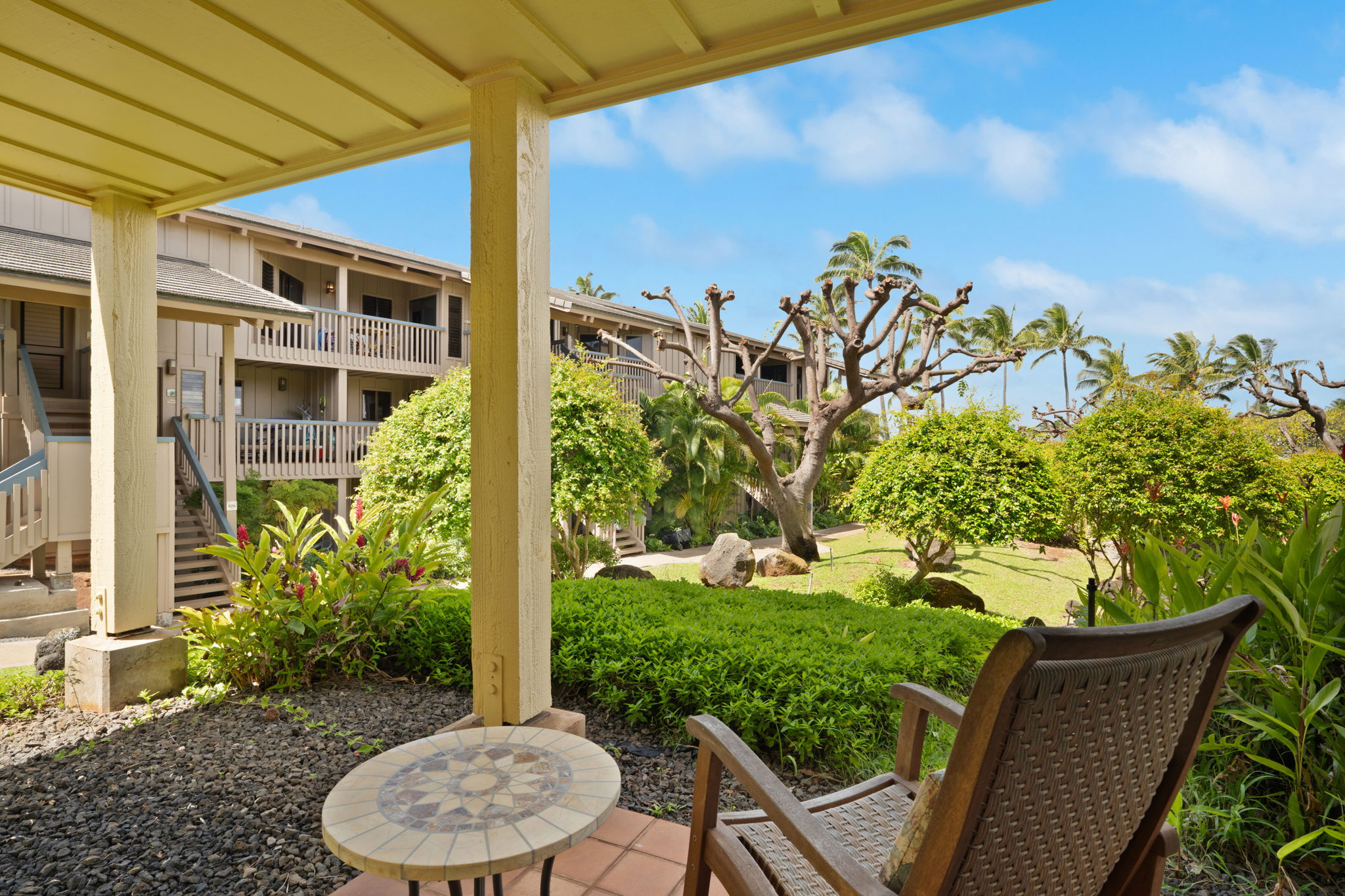 1870 Hoone Road, Unit 600 Koloa, HI 96756 - Photo 23 of 30 a view of a patio with table and chairs and potted plants