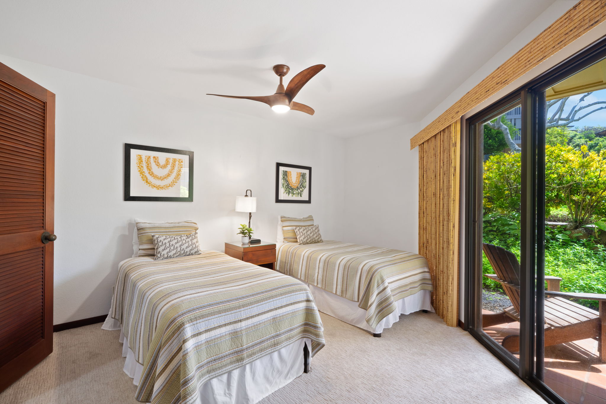 1870 Hoone Road, Unit 600 Koloa, HI 96756 - Photo 24 of 30 a bedroom with two beds and a large window