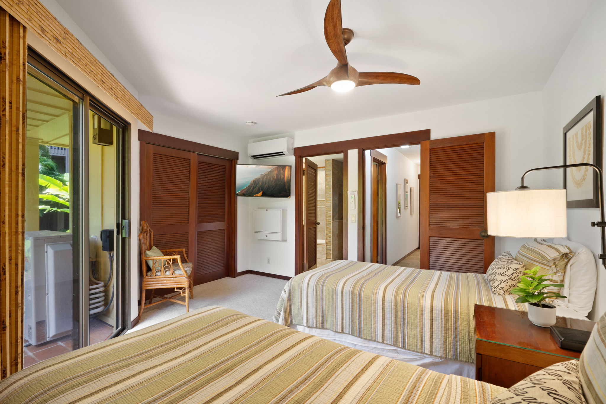 1870 Hoone Road, Unit 600 Koloa, HI 96756 - Photo 25 of 30 a bedroom with a bed lamp and a large window