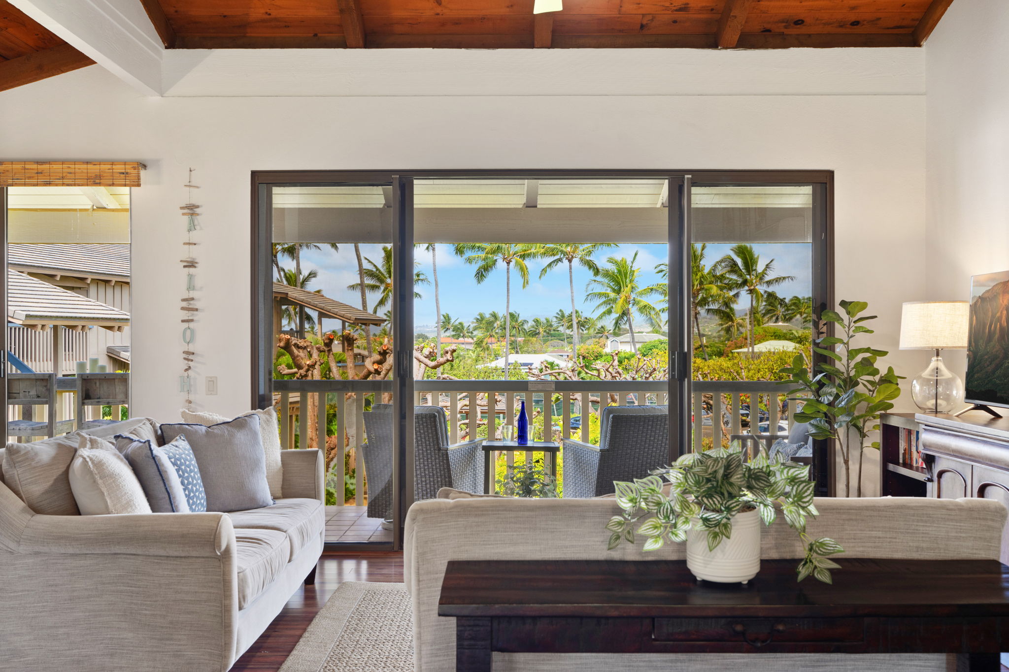 1870 Hoone Road, Unit 600 Koloa, HI 96756 - Photo 9 of 30 a living room with fireplace furniture and a large window